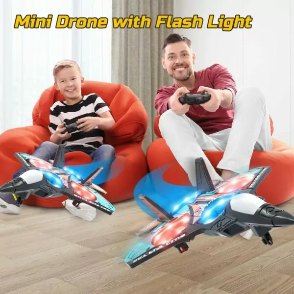 A boy and a man sitting on bean bags, controlling mini drones with flashing lights, showcasing a fun indoor playtime activity.